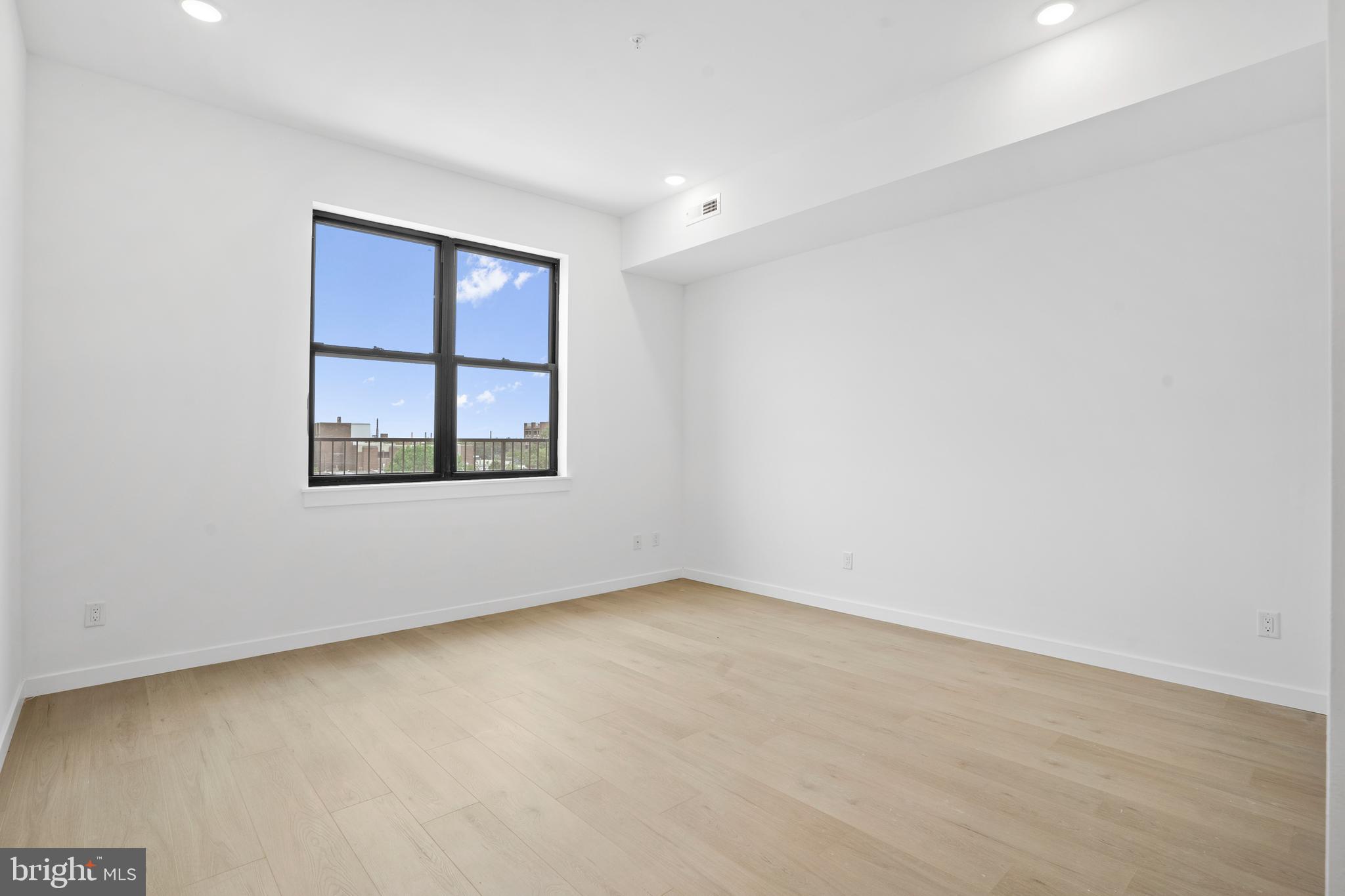 3211 Cedar Street, Unit 402 Philadelphia, PA 19134 - Photo 10 of 21 an empty room with a window