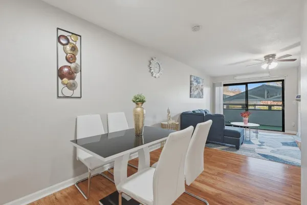 a view of a dining room with furniture large window and wooden floor