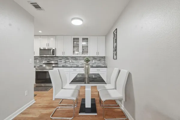 a kitchen with a dining table chairs and utility