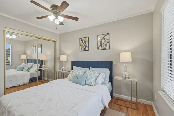 a bedroom with a bed and a chandelier