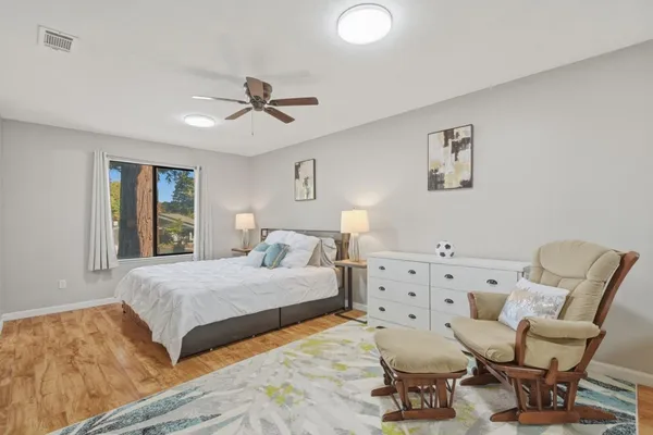 a bedroom with furniture and wooden floor