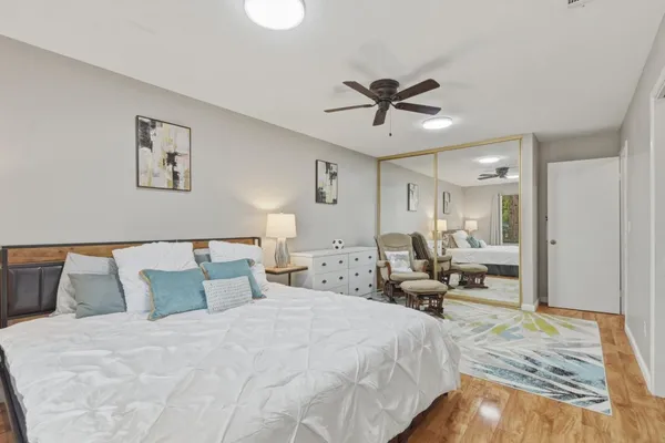 a bed room with a bed and wooden floor