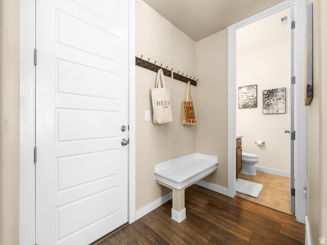 834 West 1050th Street South Springville, UT 84663 - Photo 9 of 26 Entryway featuring wood-finish flooring, a white paneled door, and a built-in bench