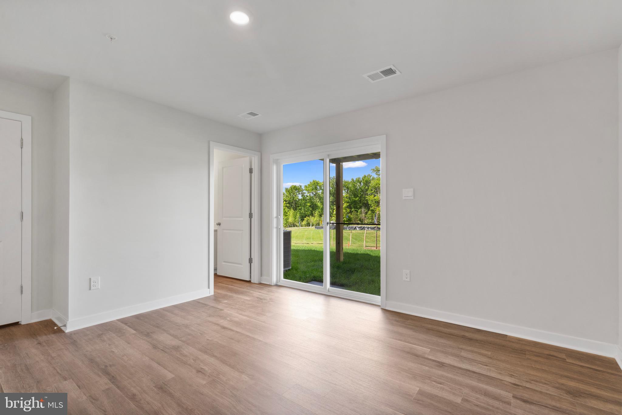 7514 Daybreak Drive Brandywine, MD 20613 - Photo 6 of 29 a view of an empty room with wooden floor and a window