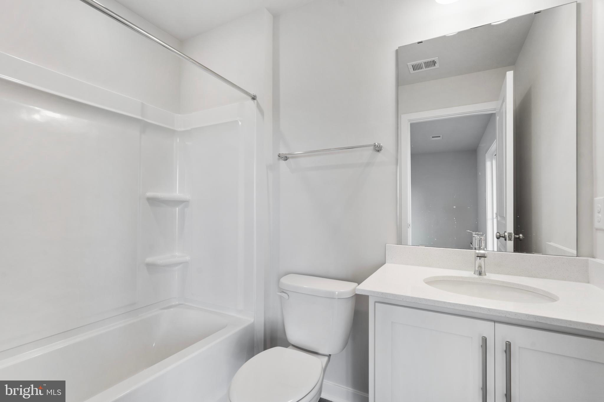 7514 Daybreak Drive Brandywine, MD 20613 - Photo 7 of 29 a bathroom with a sink toilet and shower