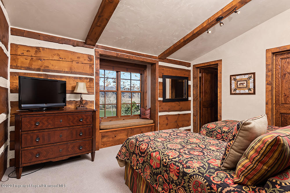 10 Arbaney Ranch Road Basalt, CO 81621 - Photo 11 of 16 a bedroom with a bed and a flat screen tv