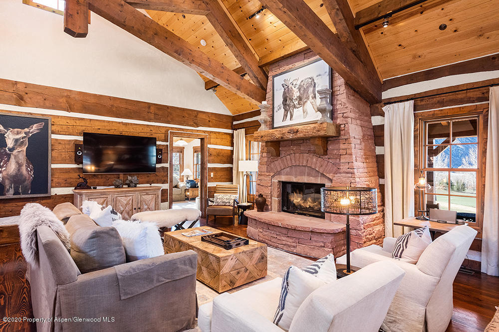 10 Arbaney Ranch Road Basalt, CO 81621 - Photo 2 of 16 a living room with furniture a flat screen tv and a fireplace