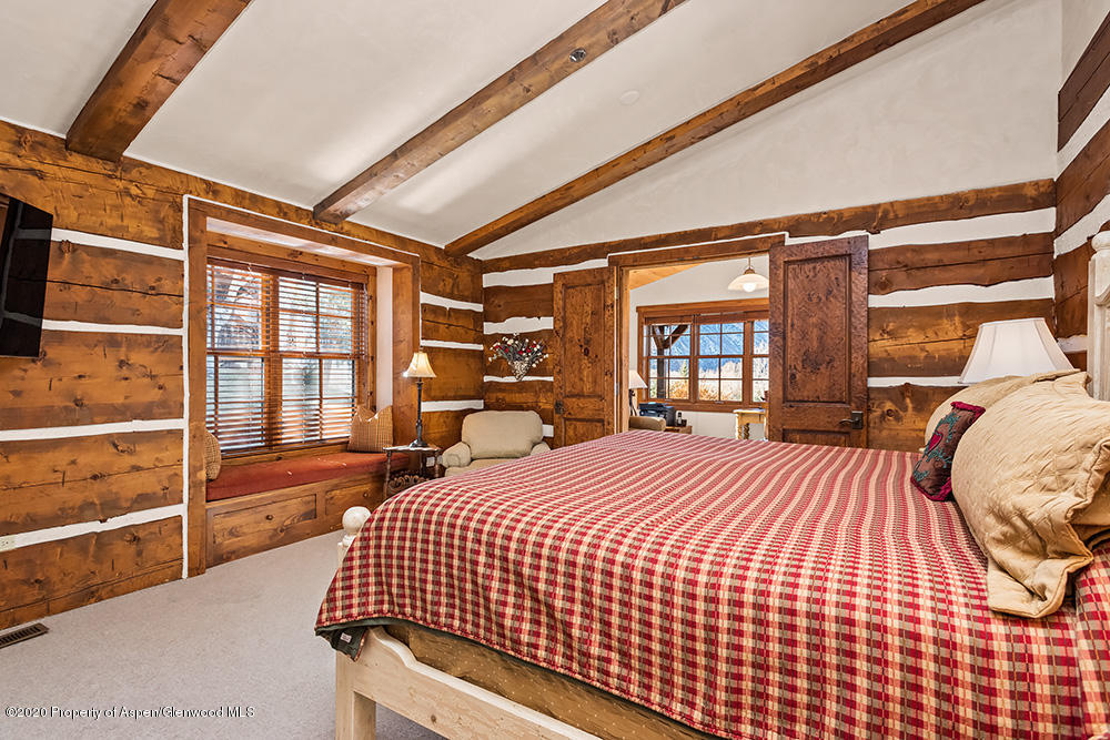 10 Arbaney Ranch Road Basalt, CO 81621 - Photo 8 of 16 a bed sitting in a bedroom next to a window