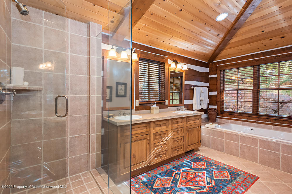 10 Arbaney Ranch Road Basalt, CO 81621 - Photo 9 of 16 a bathroom with a double vanity sink a large mirror and a shower