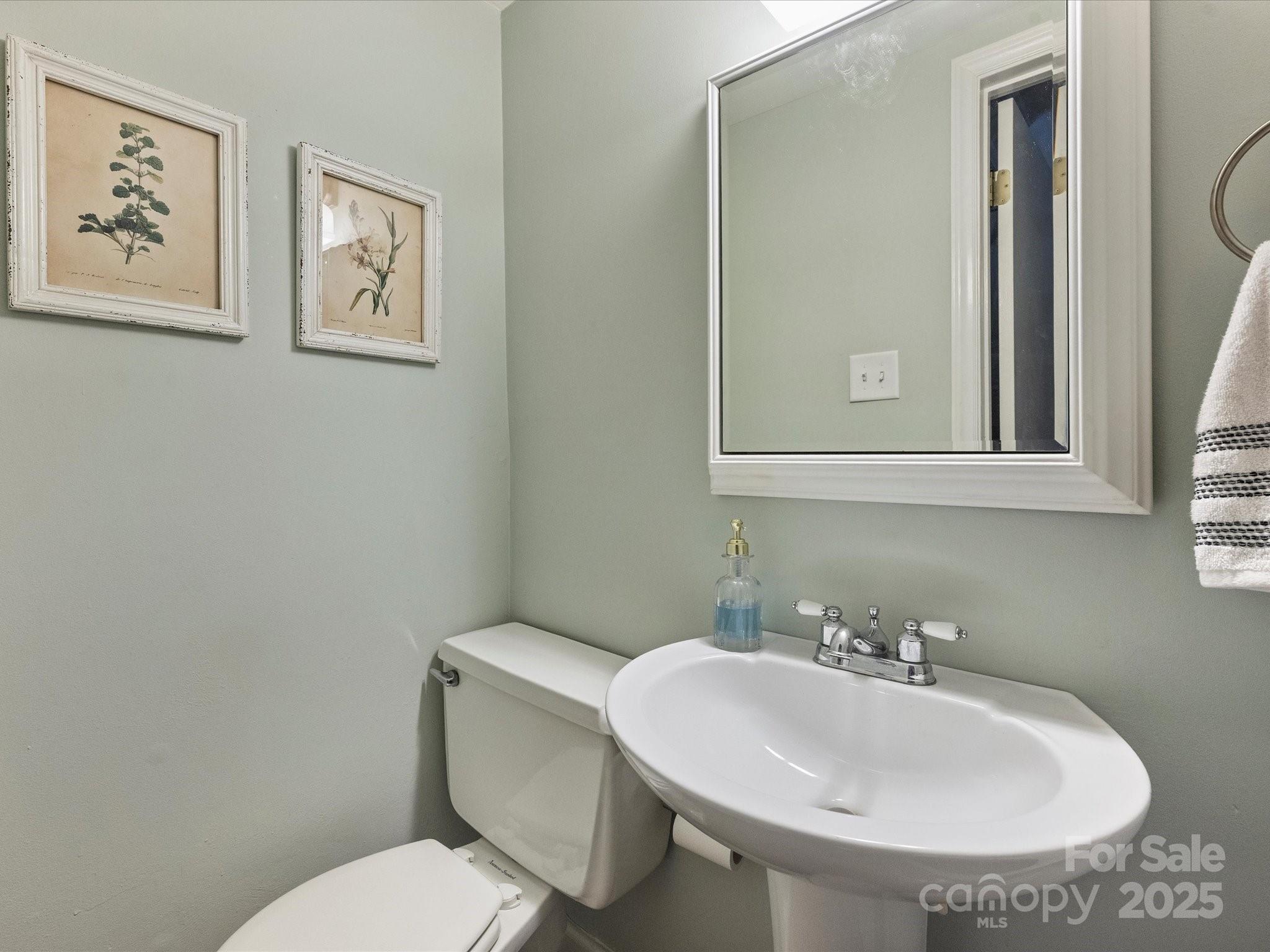 850 McAlway Road, Unit A Charlotte, NC 28211 - Photo 21 of 33 a bathroom with a toilet a sink and mirror