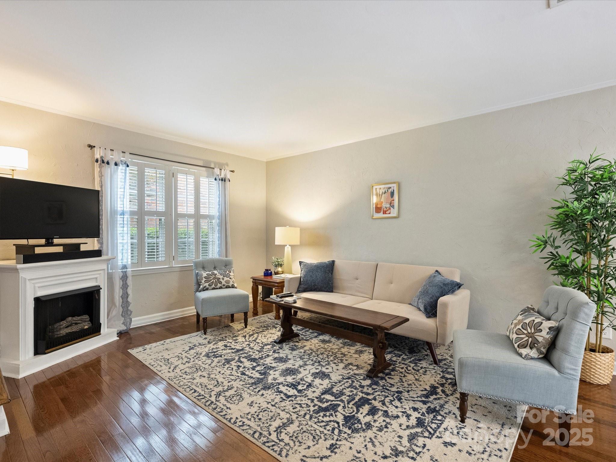850 McAlway Road, Unit A Charlotte, NC 28211 - Photo 8 of 33 a living room with furniture flat screen tv and a fireplace