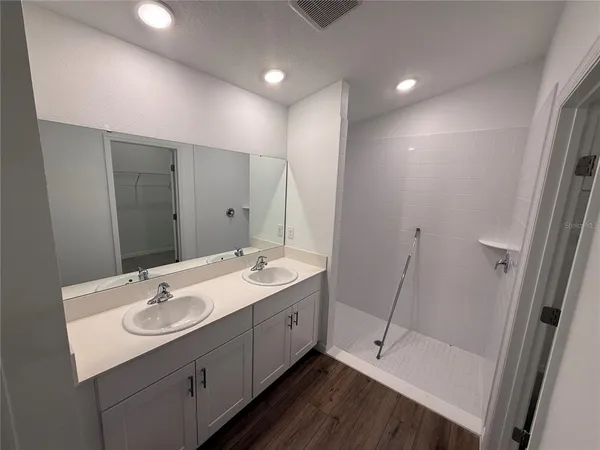 a bathroom with a double vanity sink and mirror