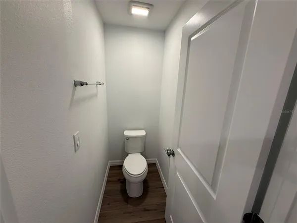a white toilet sitting next to a white sink