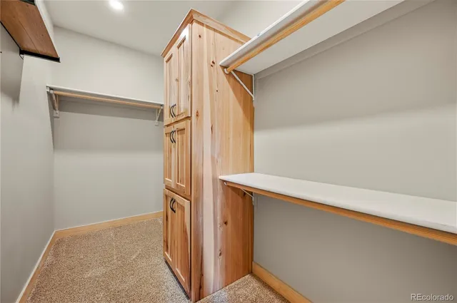a view of closet and wooden floor