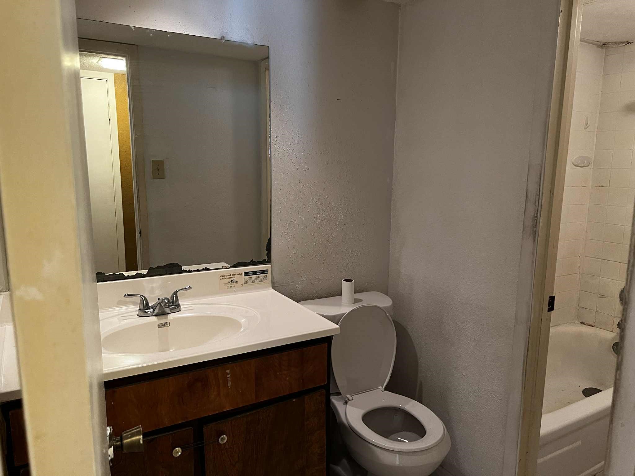 2100 Wilcrest Drive, Unit 114 Houston, TX 77077 - Photo 12 of 13 a bathroom with a granite countertop toilet sink and mirror