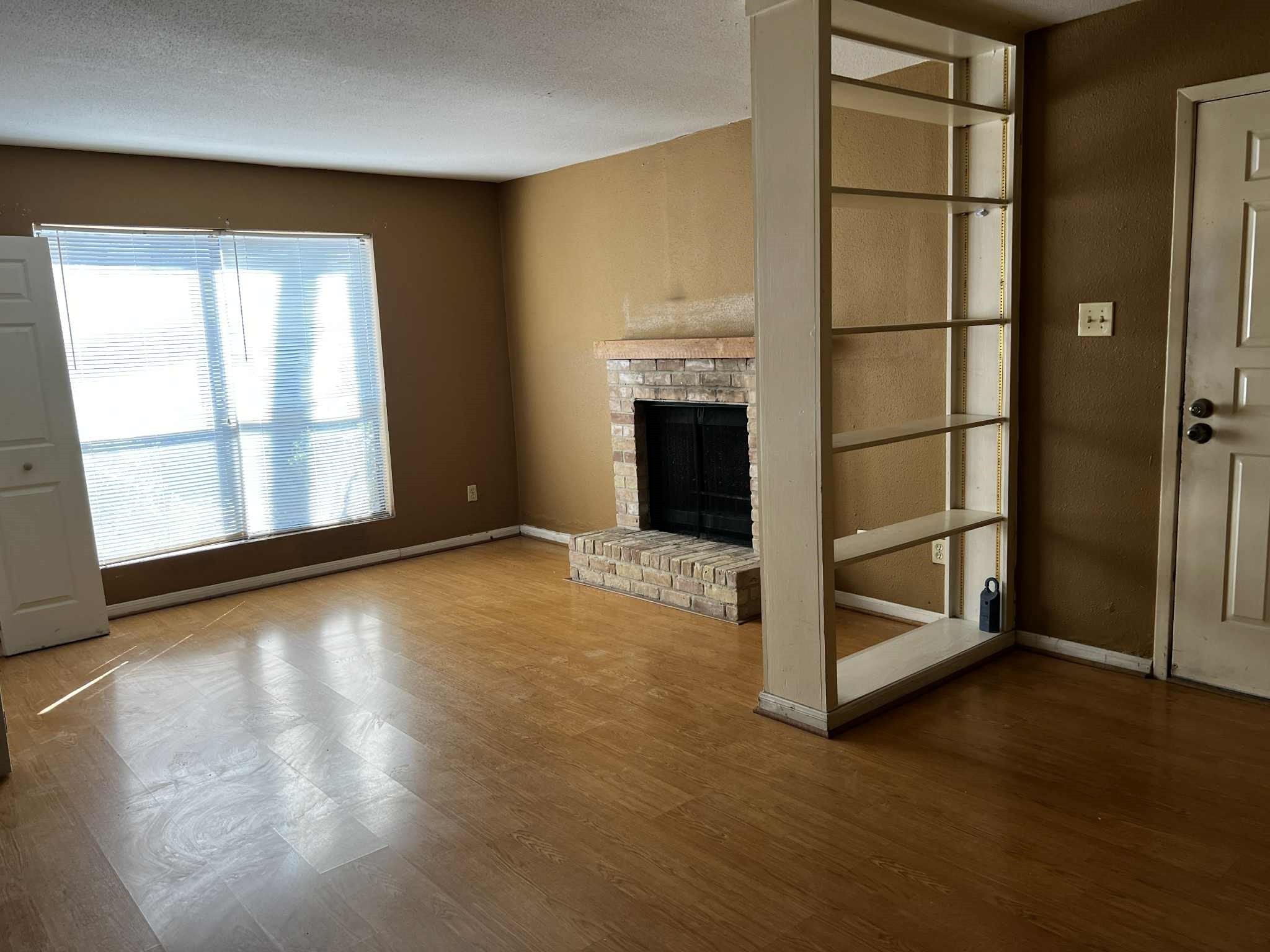 2100 Wilcrest Drive, Unit 114 Houston, TX 77077 - Photo 3 of 13 an empty room with windows fireplace and window