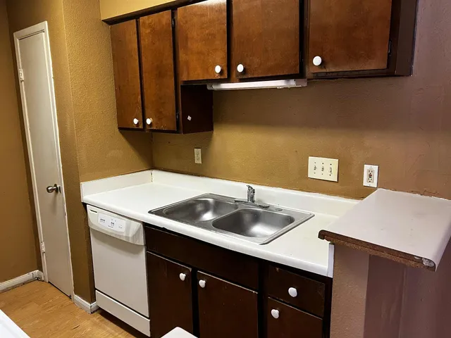 a kitchen with a sink and cabinets