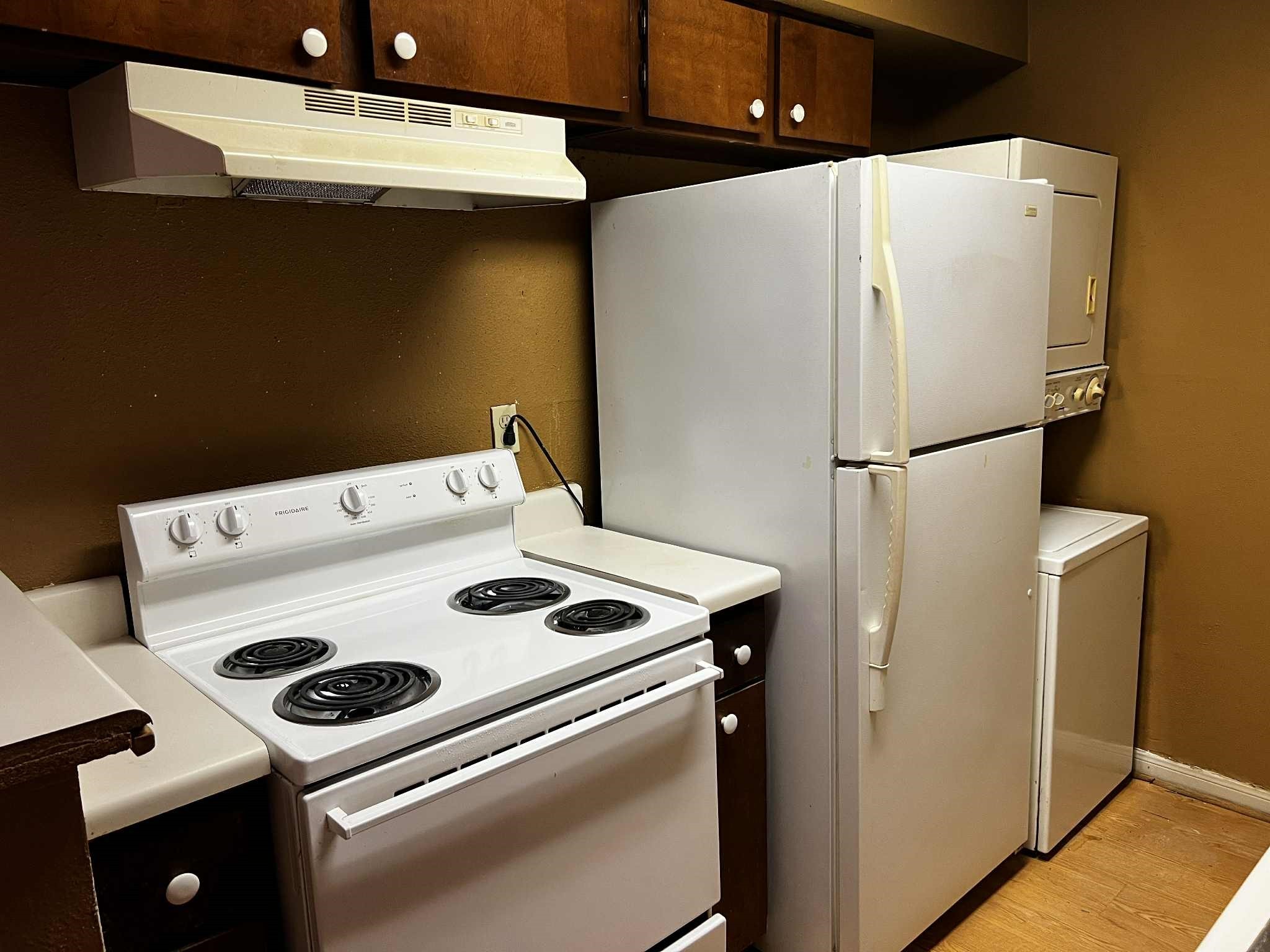 2100 Wilcrest Drive, Unit 114 Houston, TX 77077 - Photo 6 of 13 a white refrigerator freezer and a stove sitting inside of a kitchen