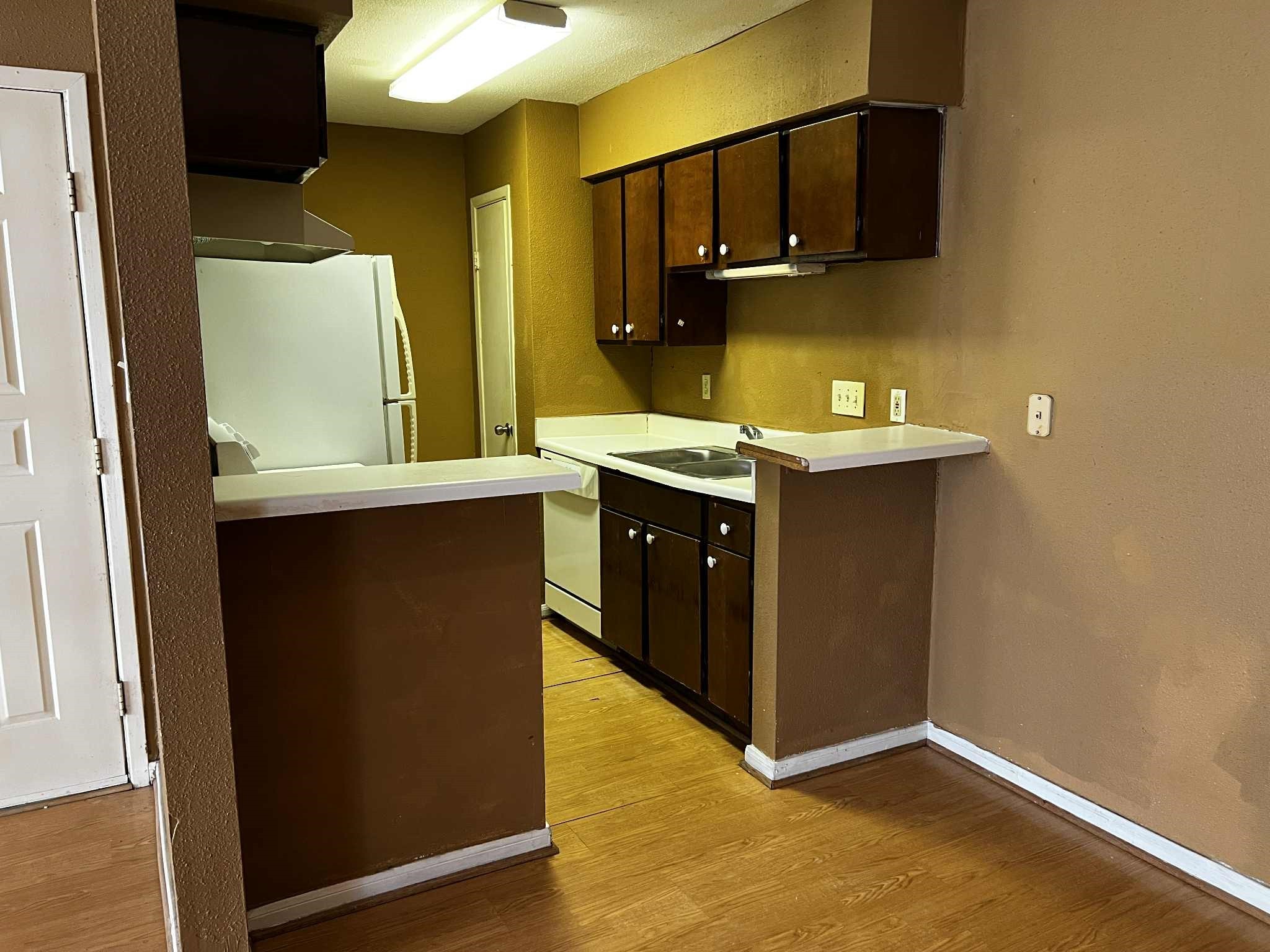2100 Wilcrest Drive, Unit 114 Houston, TX 77077 - Photo 7 of 13 a kitchen with stainless steel appliances granite countertop a sink and a refrigerator