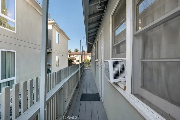 a view of staircase with railing and a fan