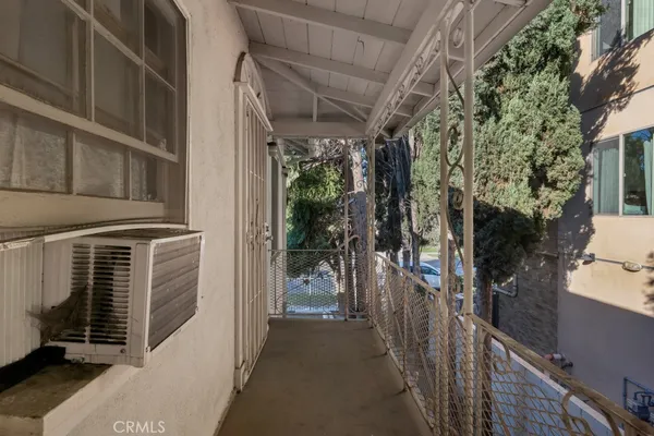 a white house that has a tree on the side of it