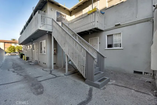 a couple of cars parked in parking area of a house