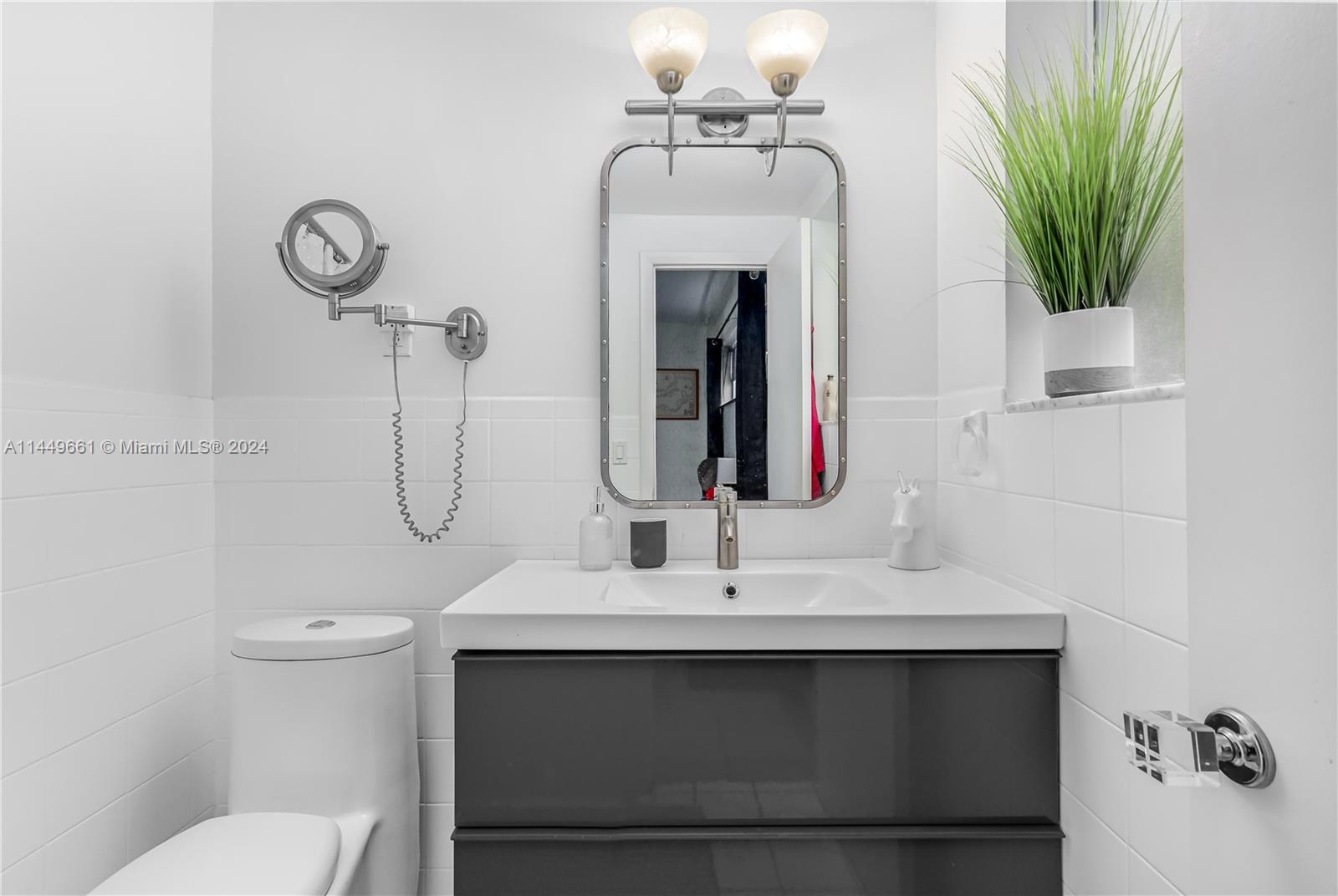 4800 Pine Tree Drive, Unit 101 Miami Beach, FL 33140 - Photo 16 of 30 a bathroom with a sink toilet and shower