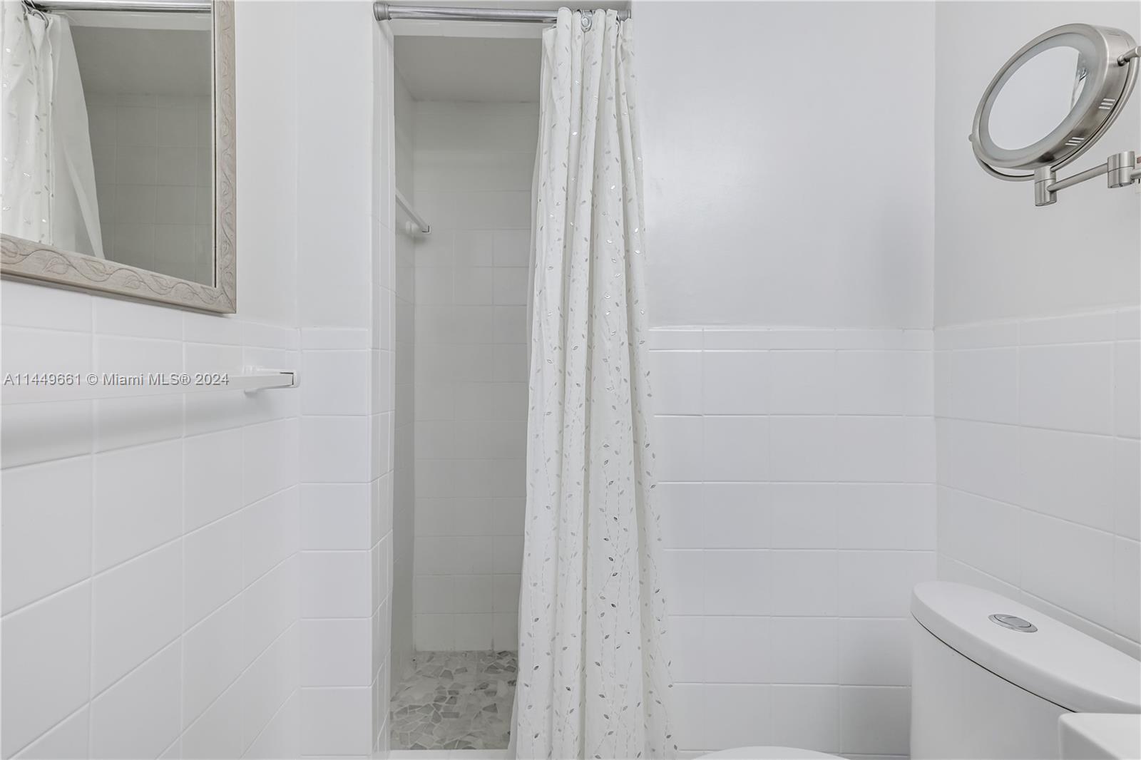 4800 Pine Tree Drive, Unit 101 Miami Beach, FL 33140 - Photo 17 of 30 a bathroom with a shower and a toilet