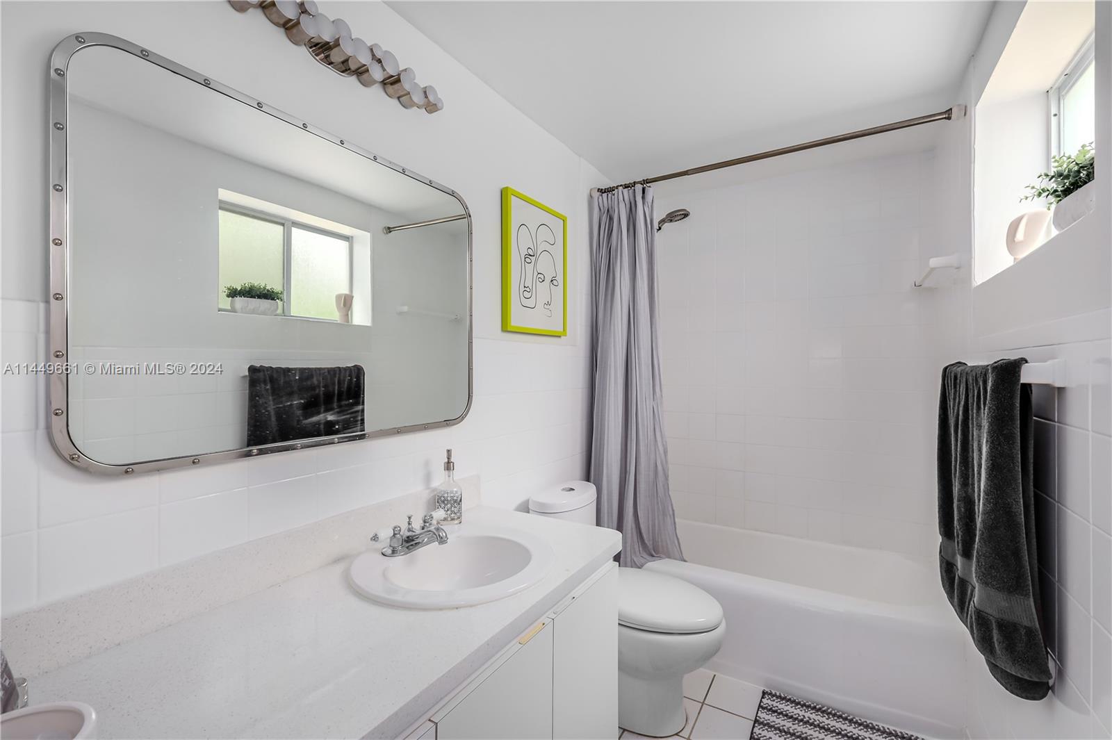 4800 Pine Tree Drive, Unit 101 Miami Beach, FL 33140 - Photo 21 of 30 a bathroom with a sink a toilet and a mirror