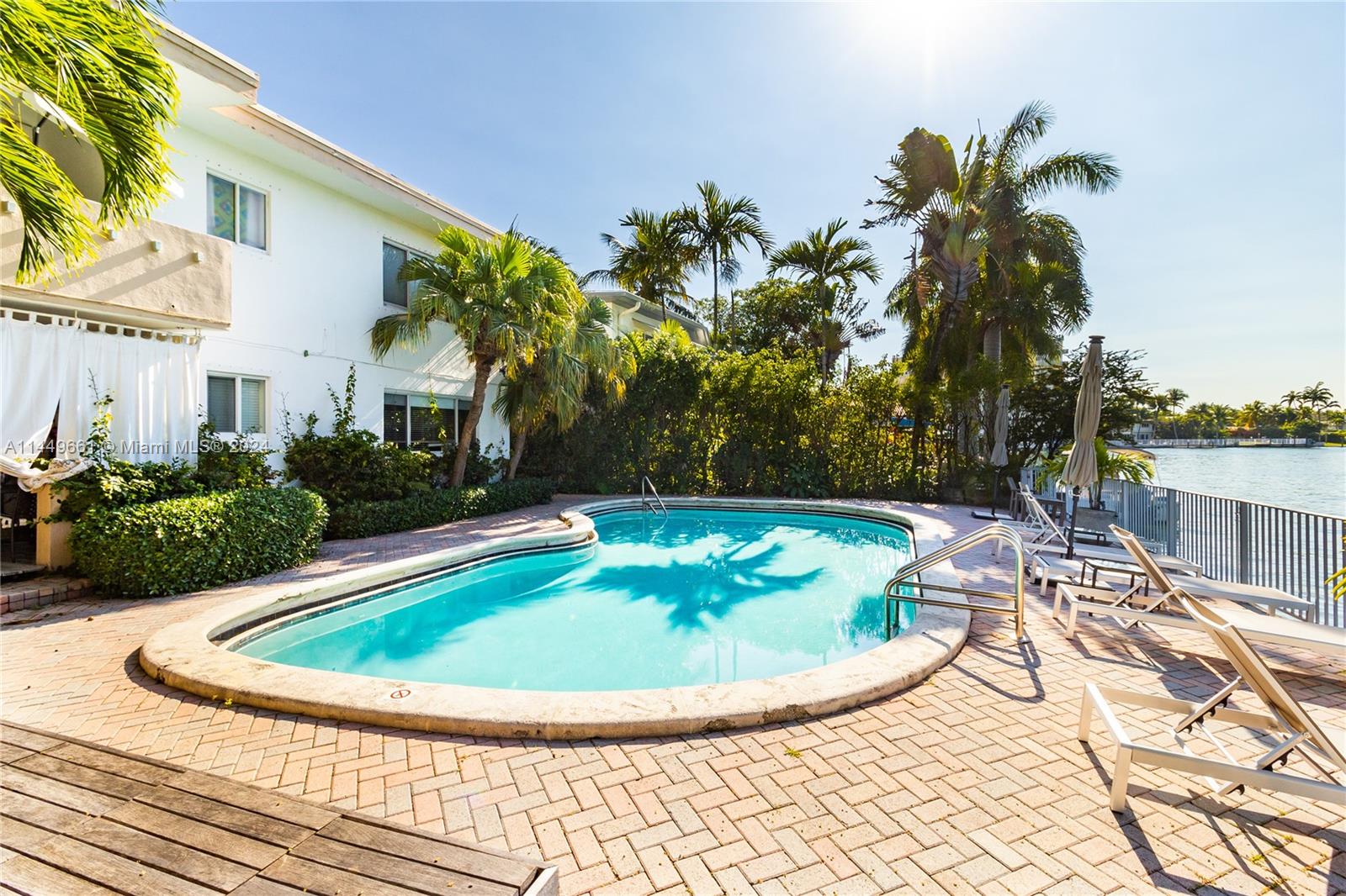 4800 Pine Tree Drive, Unit 101 Miami Beach, FL 33140 - Photo 24 of 30 a view of a swimming pool with a patio