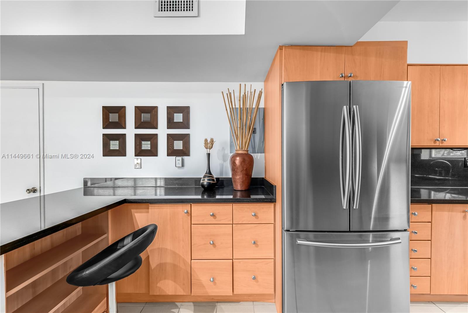 4800 Pine Tree Drive, Unit 101 Miami Beach, FL 33140 - Photo 6 of 30 a kitchen with granite countertop a refrigerator and a sink