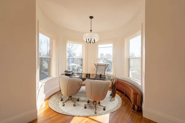 a view of a dining room with furniture windows and wooden floor