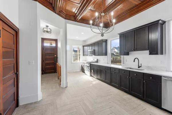 a kitchen with stainless steel appliances granite countertop a stove and a sink