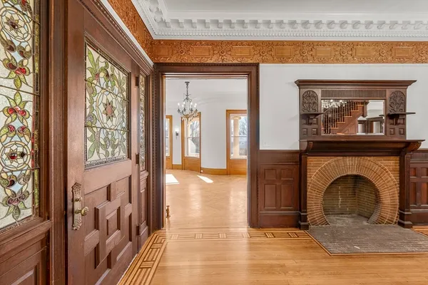 a view of a livingroom with a fireplace and painted walls