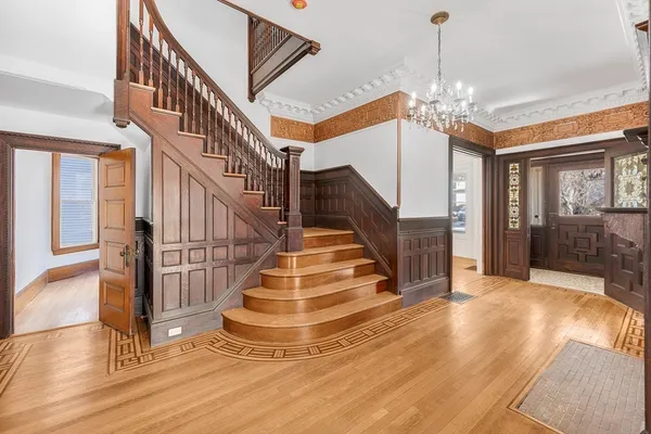 a view of entryway and hall with wooden floor