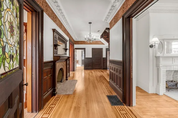 a view of a hallway with wooden floor and staircase