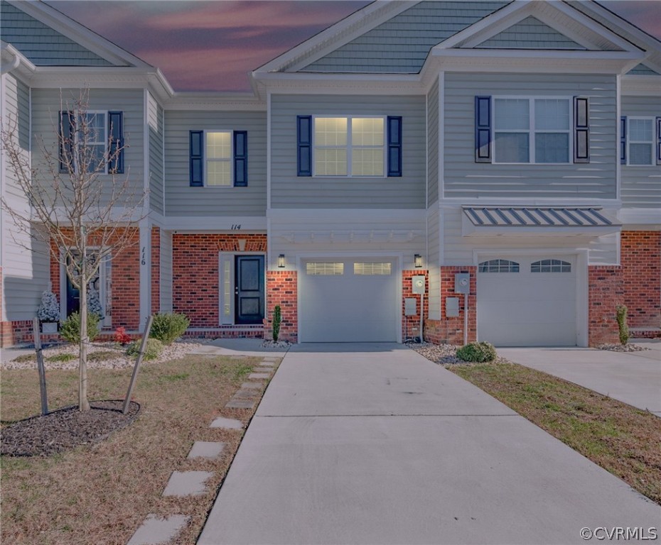 114 Two Penny Place Williamsburg, VA 23185 - Photo 1 of 25 a front view of a house with a yard and garage