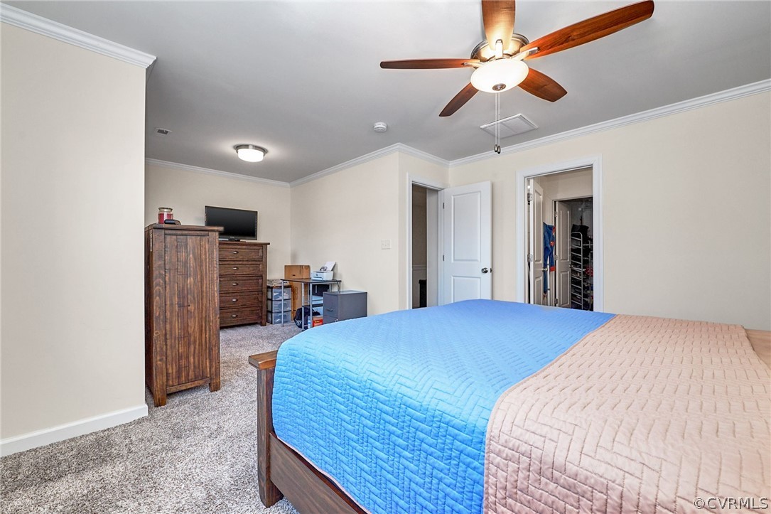 114 Two Penny Place Williamsburg, VA 23185 - Photo 21 of 25 a bedroom with bed and a chandelier