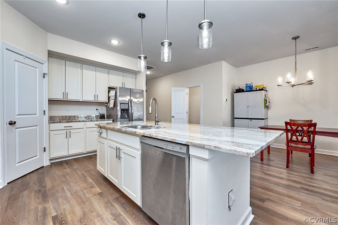 114 Two Penny Place Williamsburg, VA 23185 - Photo 8 of 25 a kitchen with cabinets wooden floor and stainless steel appliances