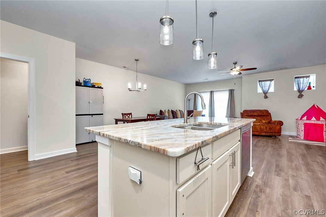 114 Two Penny Place Williamsburg, VA 23185 - Photo 9 of 25 a kitchen with kitchen island a sink stove and wooden floor