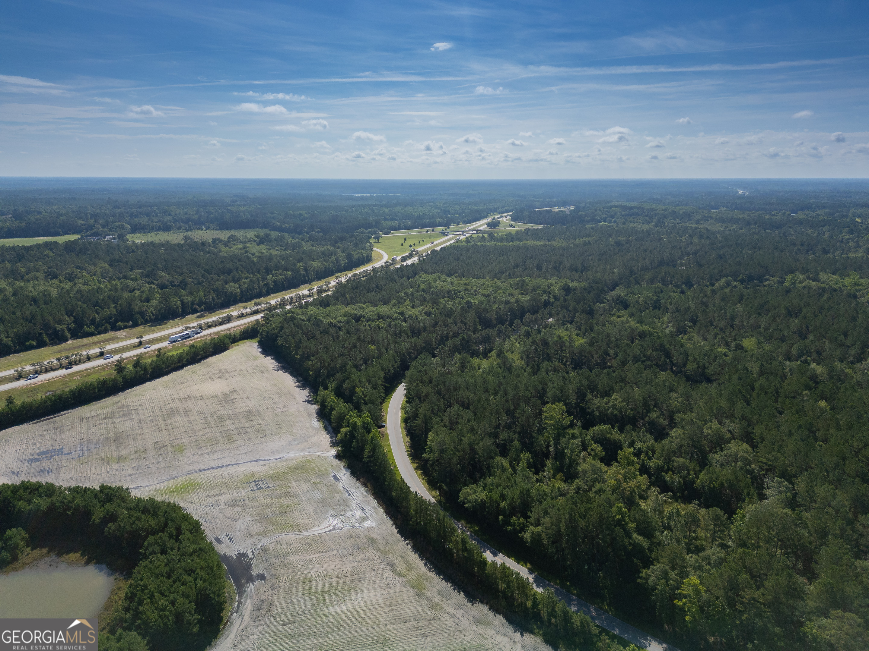 5185 Old Groveland Road Pembroke, GA 31321 - Photo 19 of 25 a view of a pathway both side of residential building and green space
