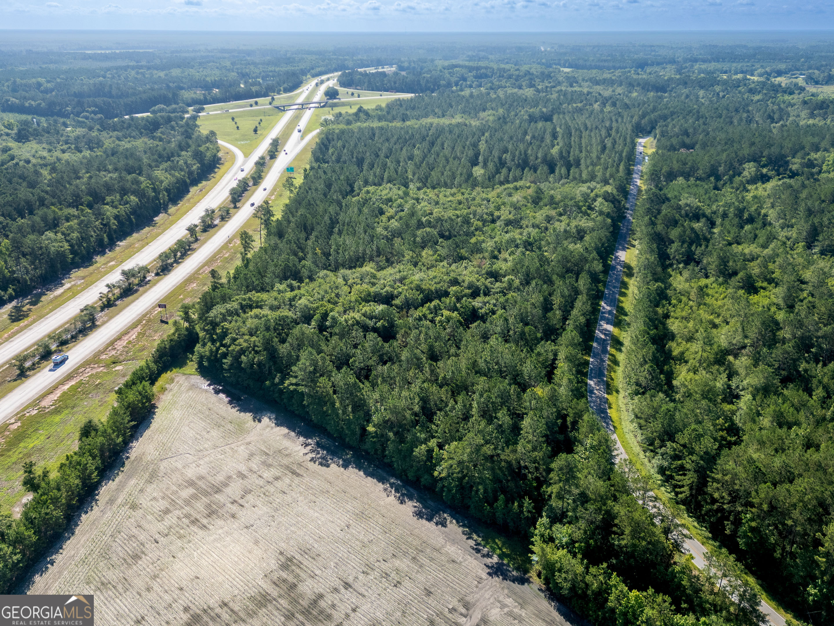 5185 Old Groveland Road Pembroke, GA 31321 - Photo 10 of 25 a view of a yard with a swimming pool and wooden fence