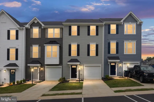 a front view of a residential apartment building with a yard