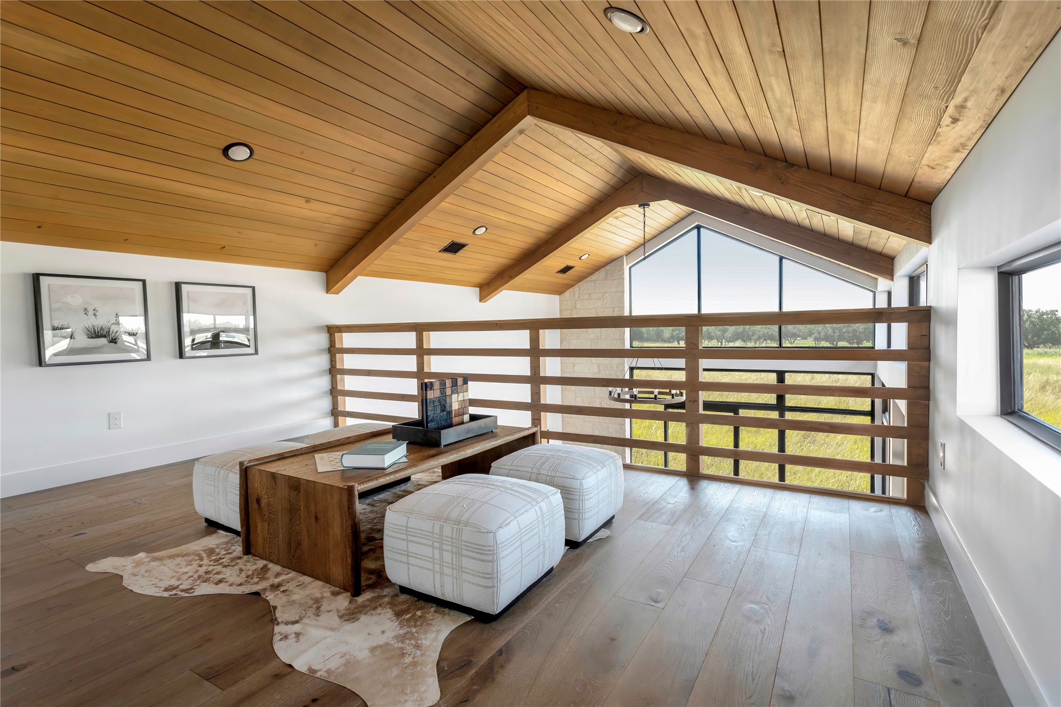 310 Hye Springs Road, Unit 107 Hye, TX 78635 - Photo 5 of 20 Upper loft retreat with exposed wood beams and elevated views overlooking the main living area and surrounding landscape.