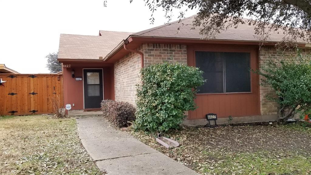 a view of a house with potted plants