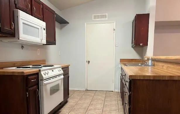 a kitchen with a stove and a microwave