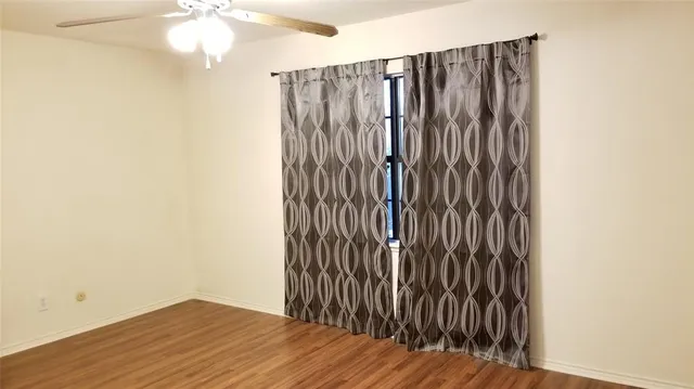 a view of a room with wooden floor