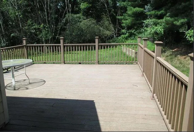 a view of balcony with wooden floor and outdoor seating