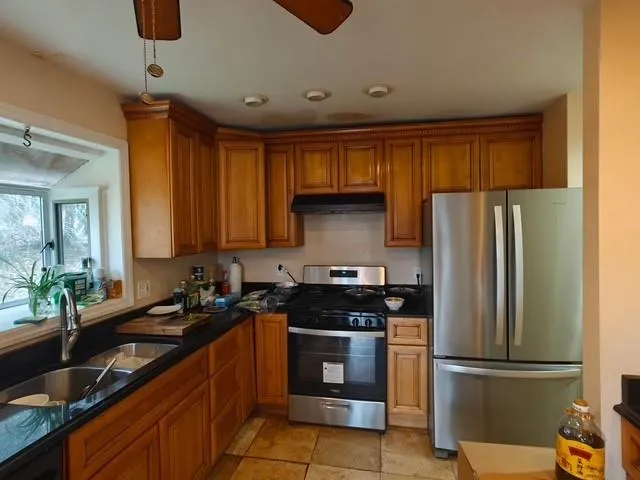 a kitchen with a refrigerator and a sink