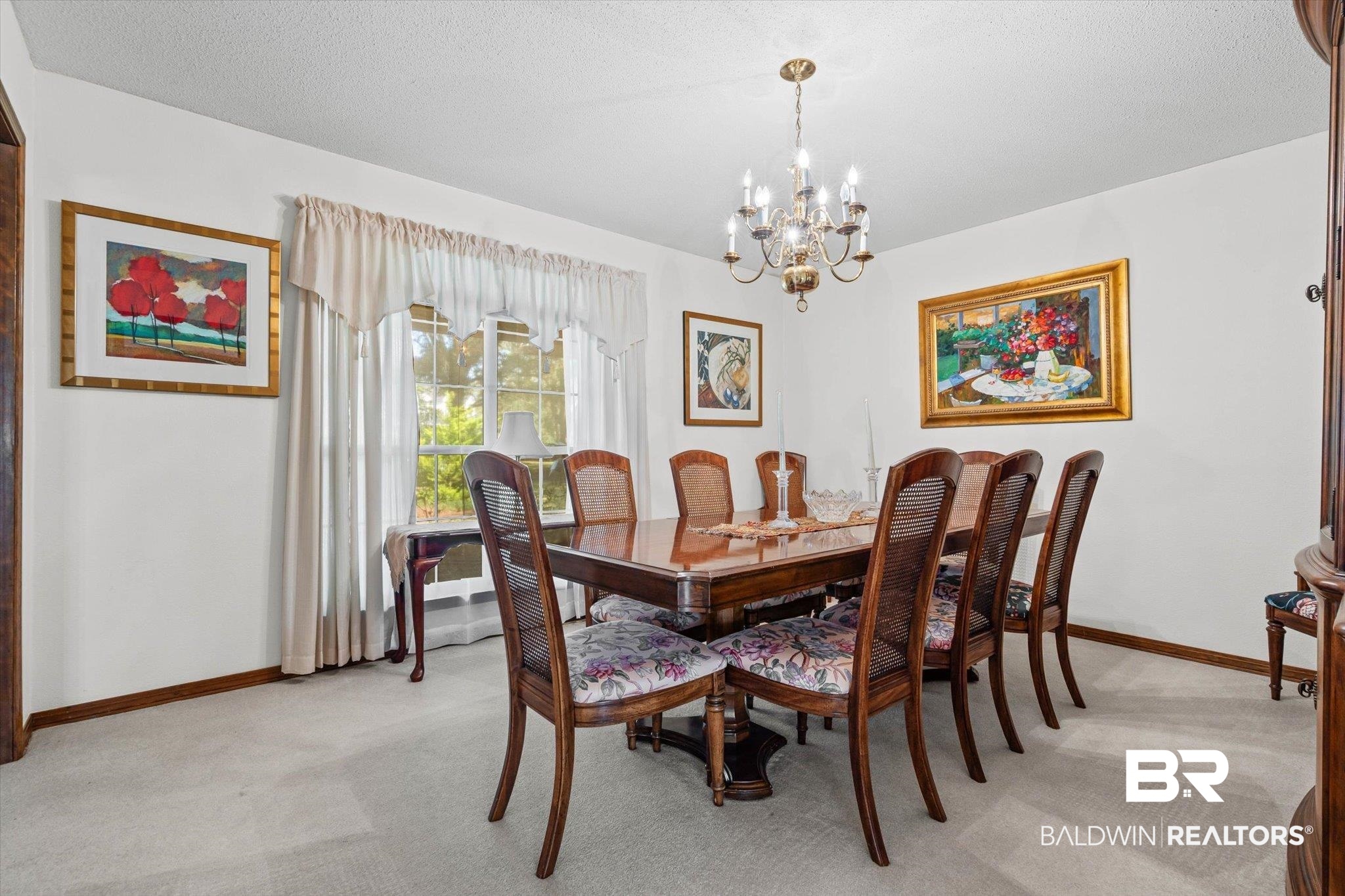 1900 Foxfire Road Mobile, AL 36618 - Photo 6 of 36 Dining area with light colored carpet, a chandelier, and a textured ceiling